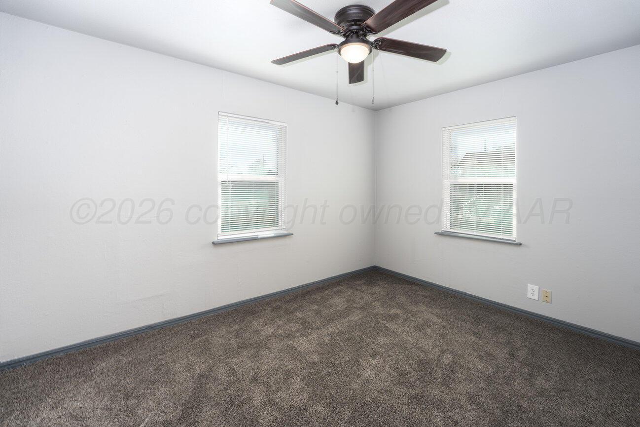 4224 South Polk Street Amarillo, TX 79110 - Photo 28 of 55 an empty room with a window and a ceiling fan