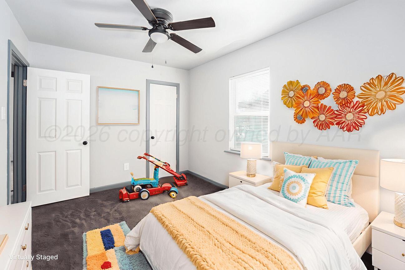 4224 South Polk Street Amarillo, TX 79110 - Photo 31 of 55 a bedroom that has a bed and a table in it