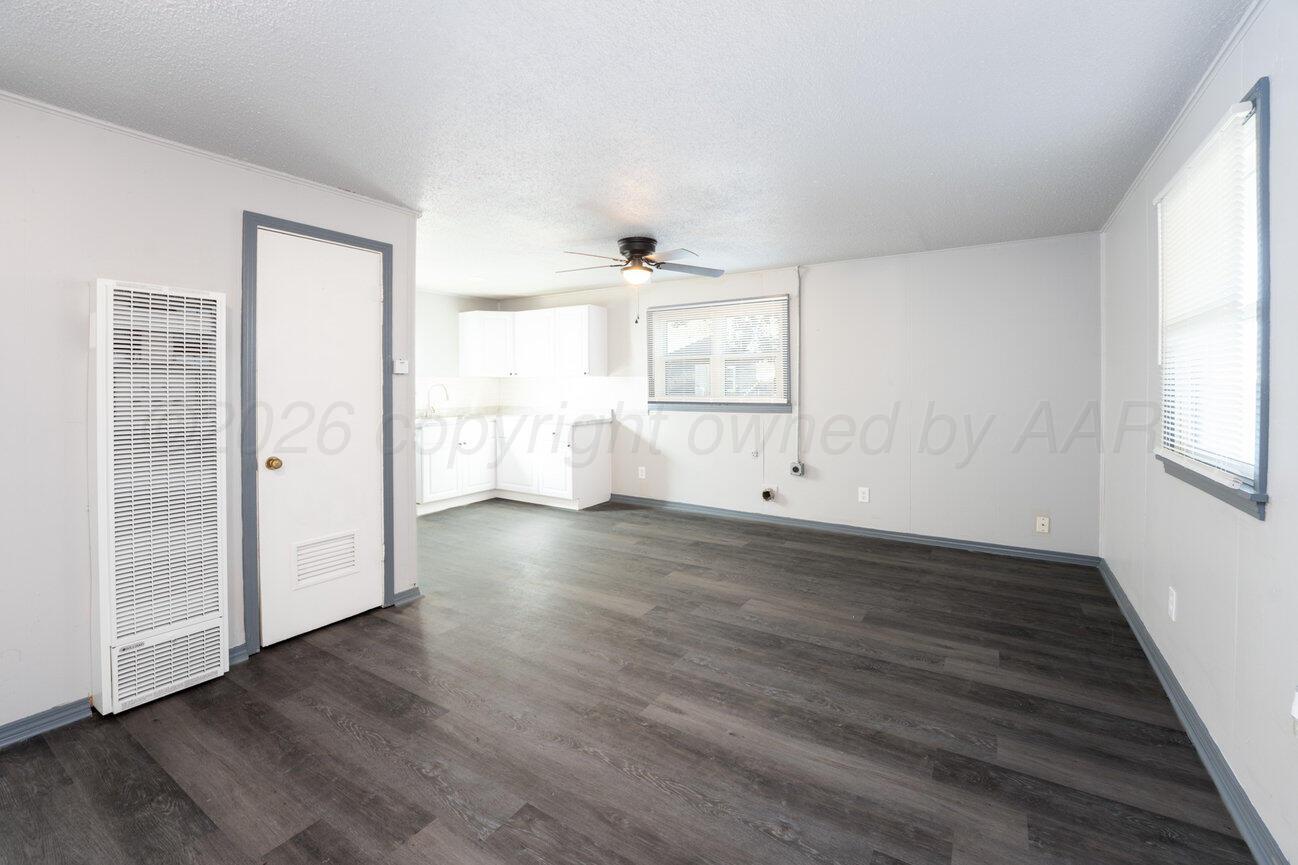 4224 South Polk Street Amarillo, TX 79110 - Photo 40 of 55 an empty room with wooden floor and windows