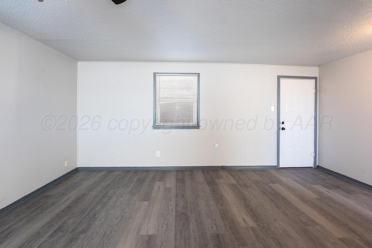 4224 South Polk Street Amarillo, TX 79110 - Photo 43 of 55 an empty room with wooden floor and windows