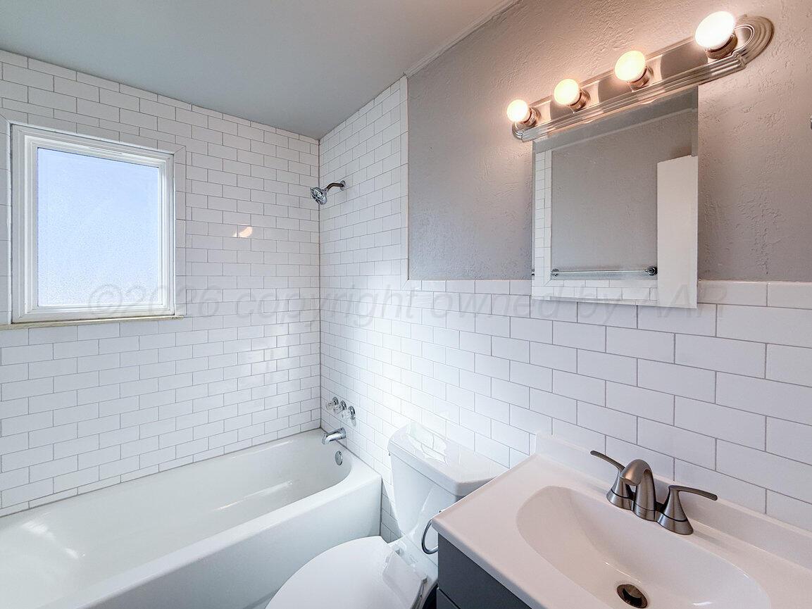 4224 South Polk Street Amarillo, TX 79110 - Photo 47 of 55 a bathroom with a sink mirror and a bathtub