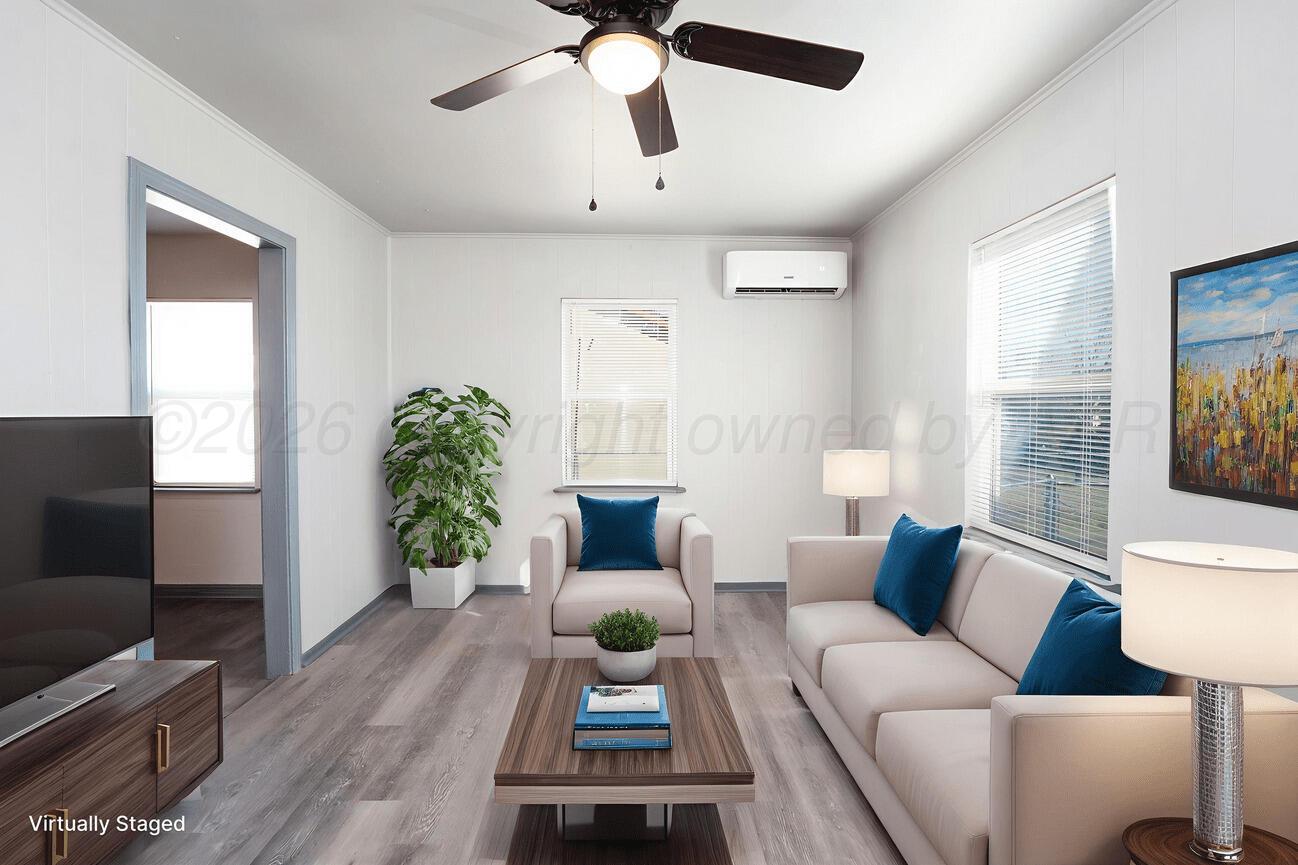 4224 South Polk Street Amarillo, TX 79110 - Photo 8 of 55 a living room with furniture and a flat screen tv
