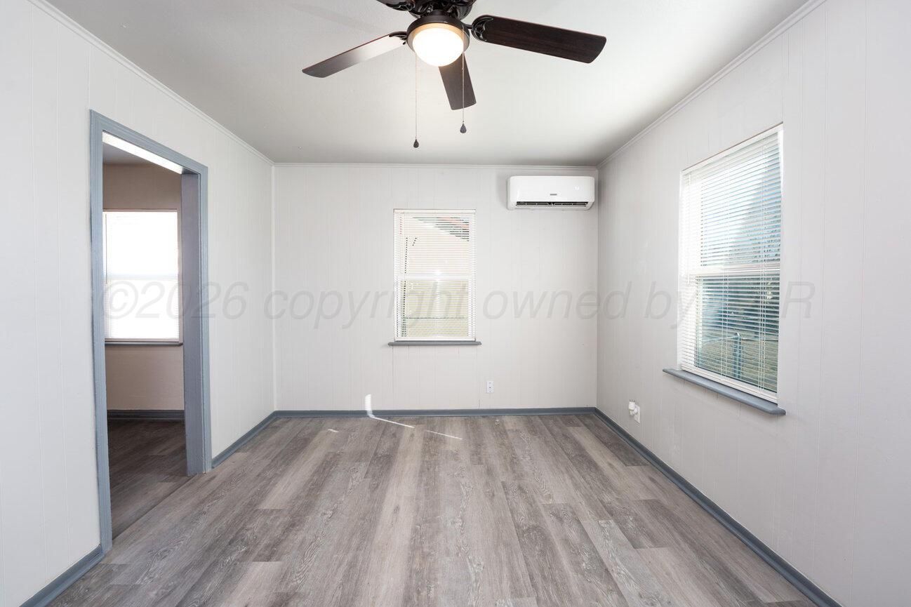 4224 South Polk Street Amarillo, TX 79110 - Photo 9 of 55 wooden floor in an empty room with a window