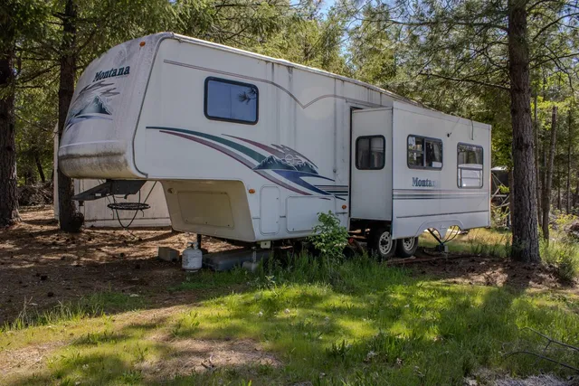 a view of entryway with a tree and wooden fence