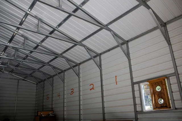a aerial view of a house with a yard and sitting area