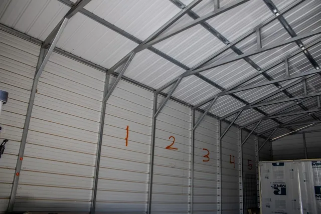 an aerial view of residential house with outdoor space and trees all around