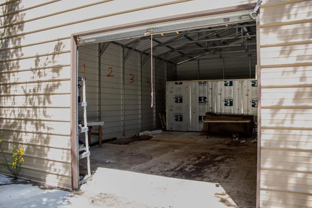 a view of a backyard with plants and outdoor seating