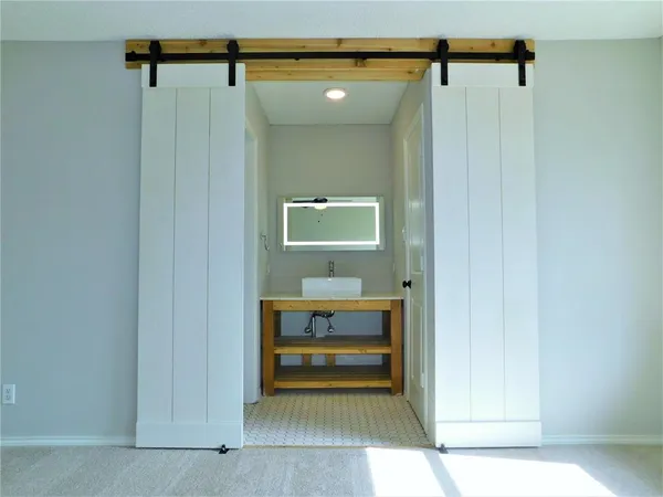 a view of kitchen sink and cabinet with wooden floor