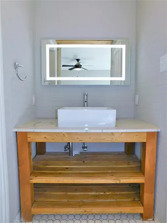 a white toilet next to a bathroom