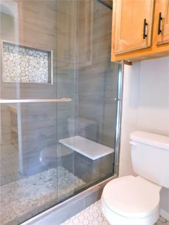 a view of a yard with wooden fence