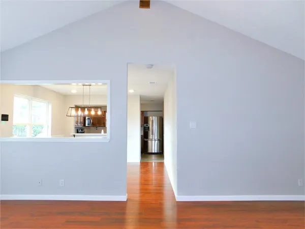 a view of a room with wooden floor and window
