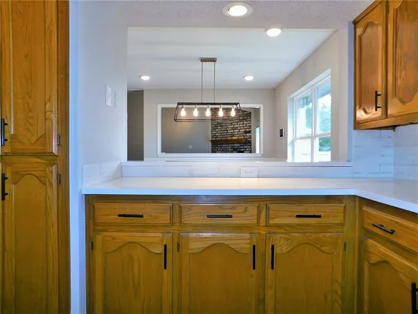 a view of a kitchen counter space and a window