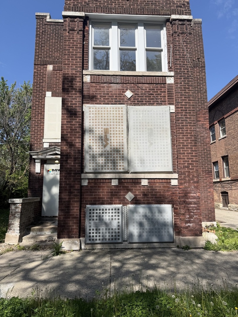 6716 South May Street Chicago, IL 60621 - Photo 1 of 9 a brick building with a small yard