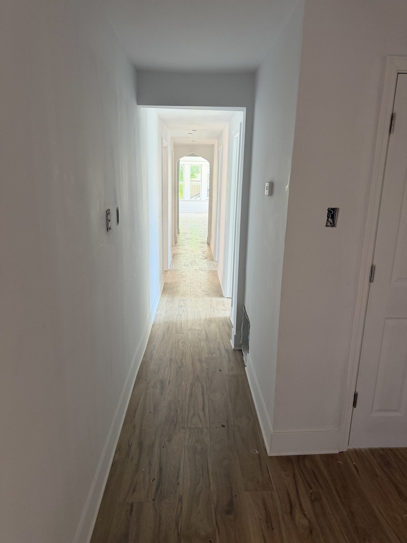 6716 South May Street Chicago, IL 60621 - Photo 4 of 9 a view of a hallway with wooden floor