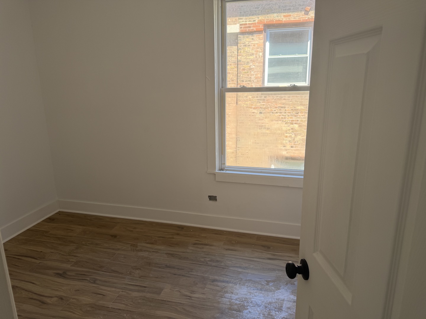 6716 South May Street Chicago, IL 60621 - Photo 6 of 9 a view of a small space with wooden floor and a window