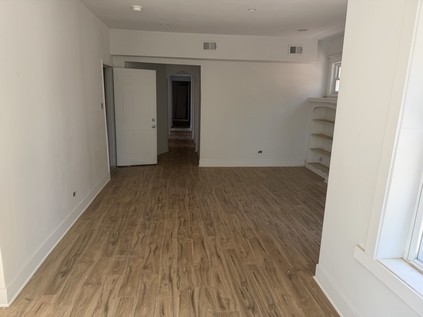6716 South May Street Chicago, IL 60621 - Photo 8 of 9 a view of a hallway with wooden floor