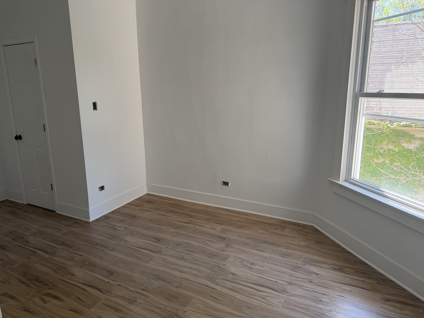 6716 South May Street Chicago, IL 60621 - Photo 9 of 9 a view of an empty room with wooden floor and a window