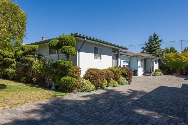 a front view of a house with garden