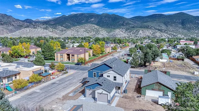 an aerial view of a house with a mountain