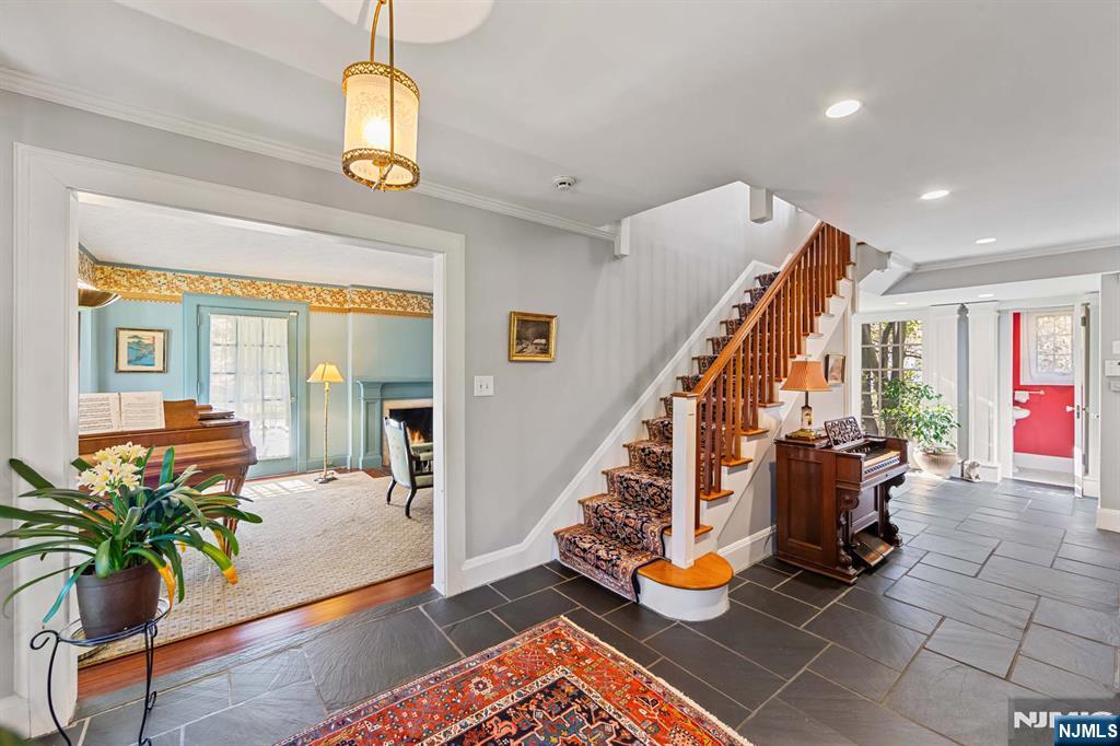 116 Lydecker Street Englewood, NJ 07631 - Photo 19 of 46 a view of an entryway with wooden floor and a chandelier