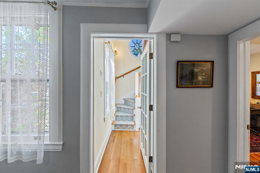 116 Lydecker Street Englewood, NJ 07631 - Photo 31 of 46 a view of a hallway with wooden floor and a dining room