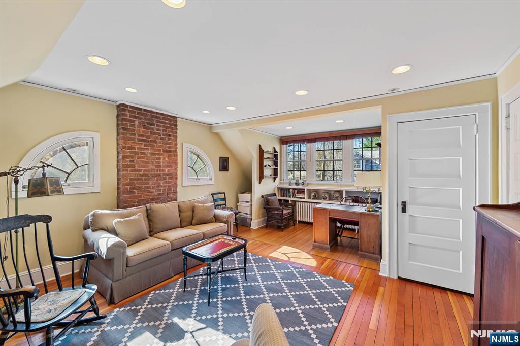 116 Lydecker Street Englewood, NJ 07631 - Photo 35 of 46 a living room with furniture a rug and a table