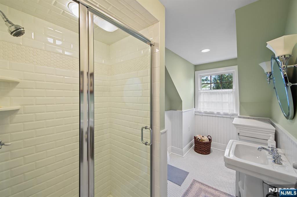 116 Lydecker Street Englewood, NJ 07631 - Photo 37 of 46 a bathroom with a sink and a mirror