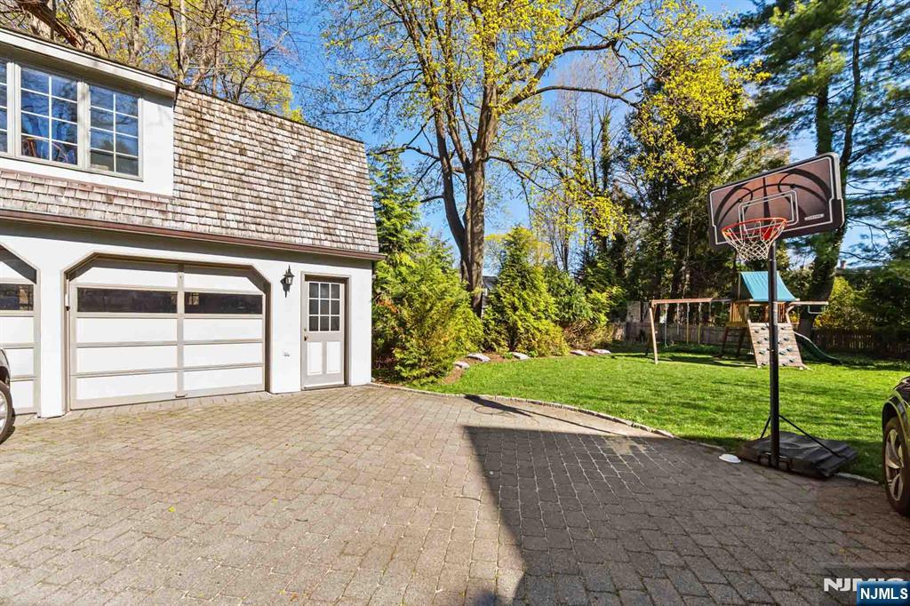116 Lydecker Street Englewood, NJ 07631 - Photo 42 of 46 a view of a house with a yard and garage