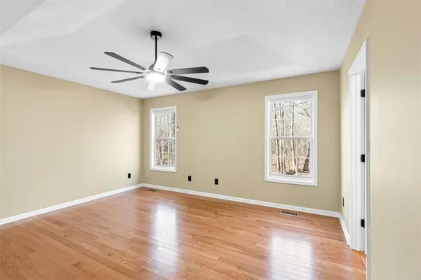 a view of an empty room with wooden floor