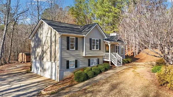 a front view of a house with a garden