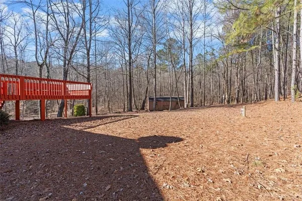 a view of a backyard with large trees