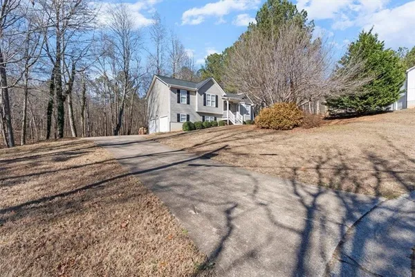 a front view of a house with a yard covered in snow