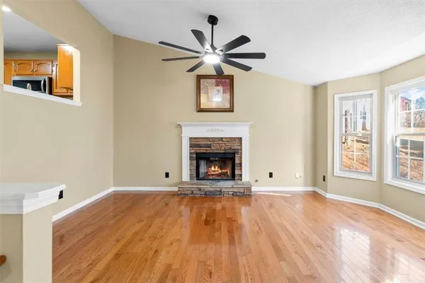 a view of empty room with a fireplace and fan