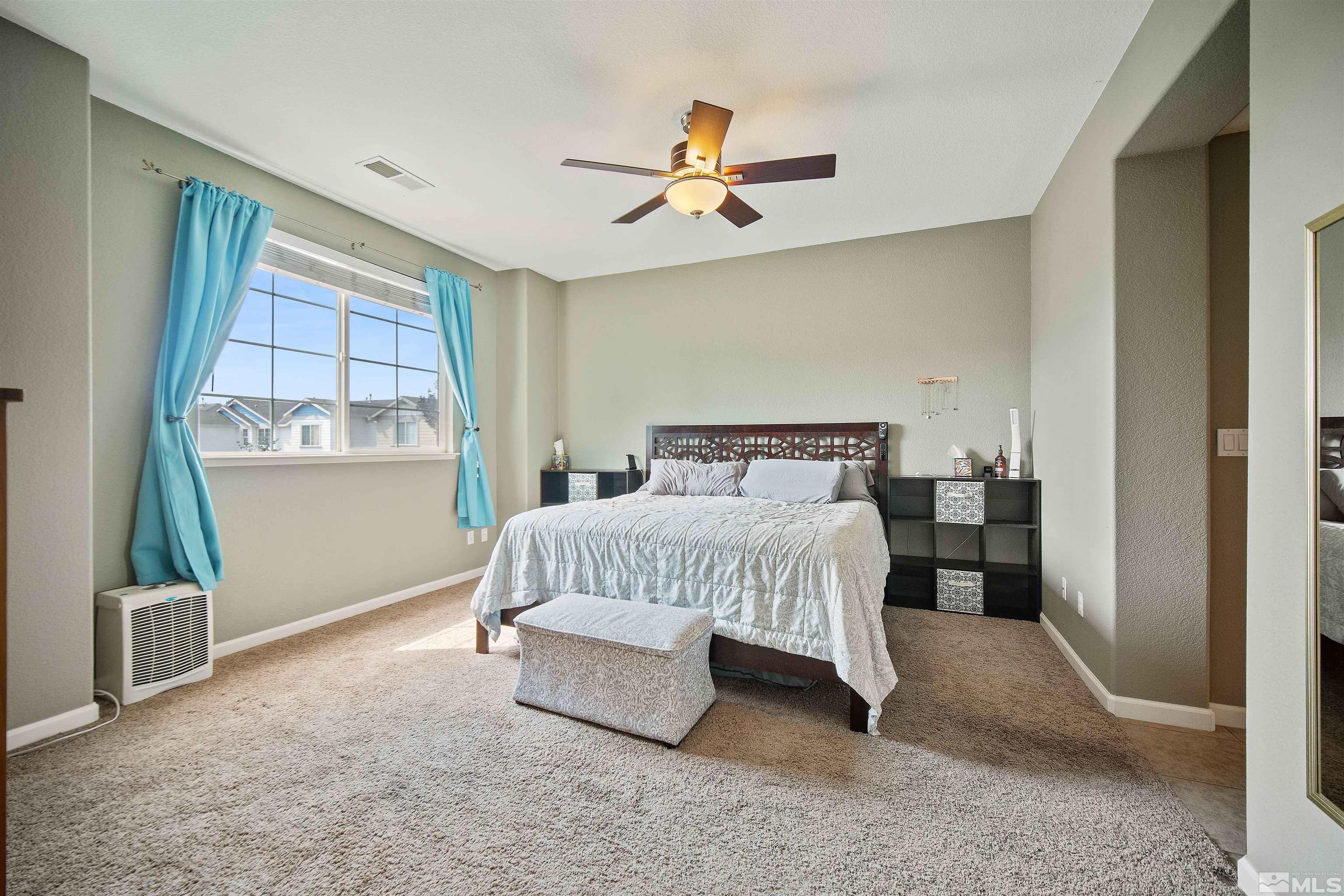 2110 Hellaby Lane Reno, NV 89502 - Photo 17 of 29 a bedroom with a bed and a window