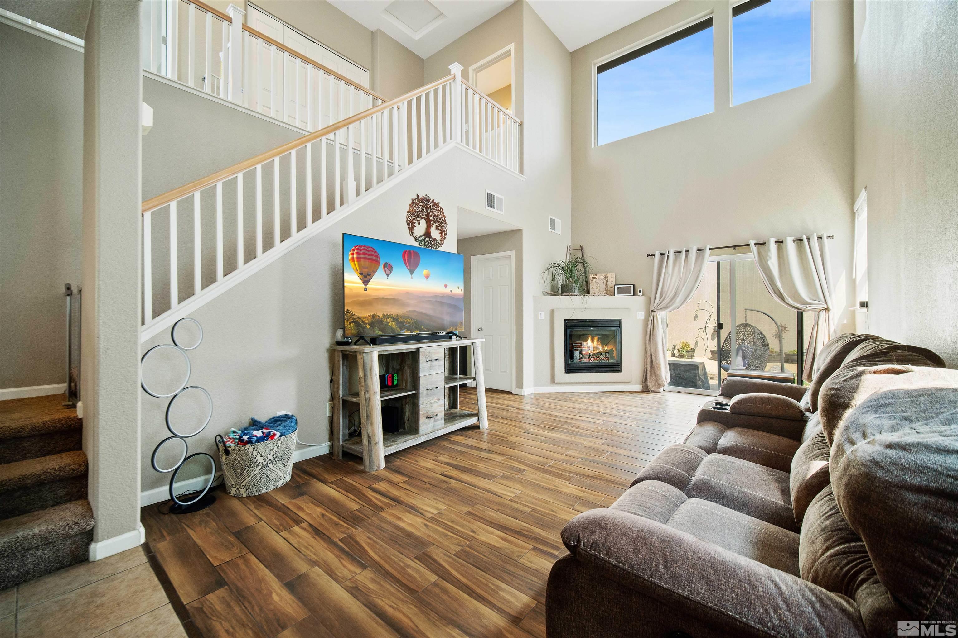 2110 Hellaby Lane Reno, NV 89502 - Photo 4 of 29 a living room with furniture stairs and a fireplace