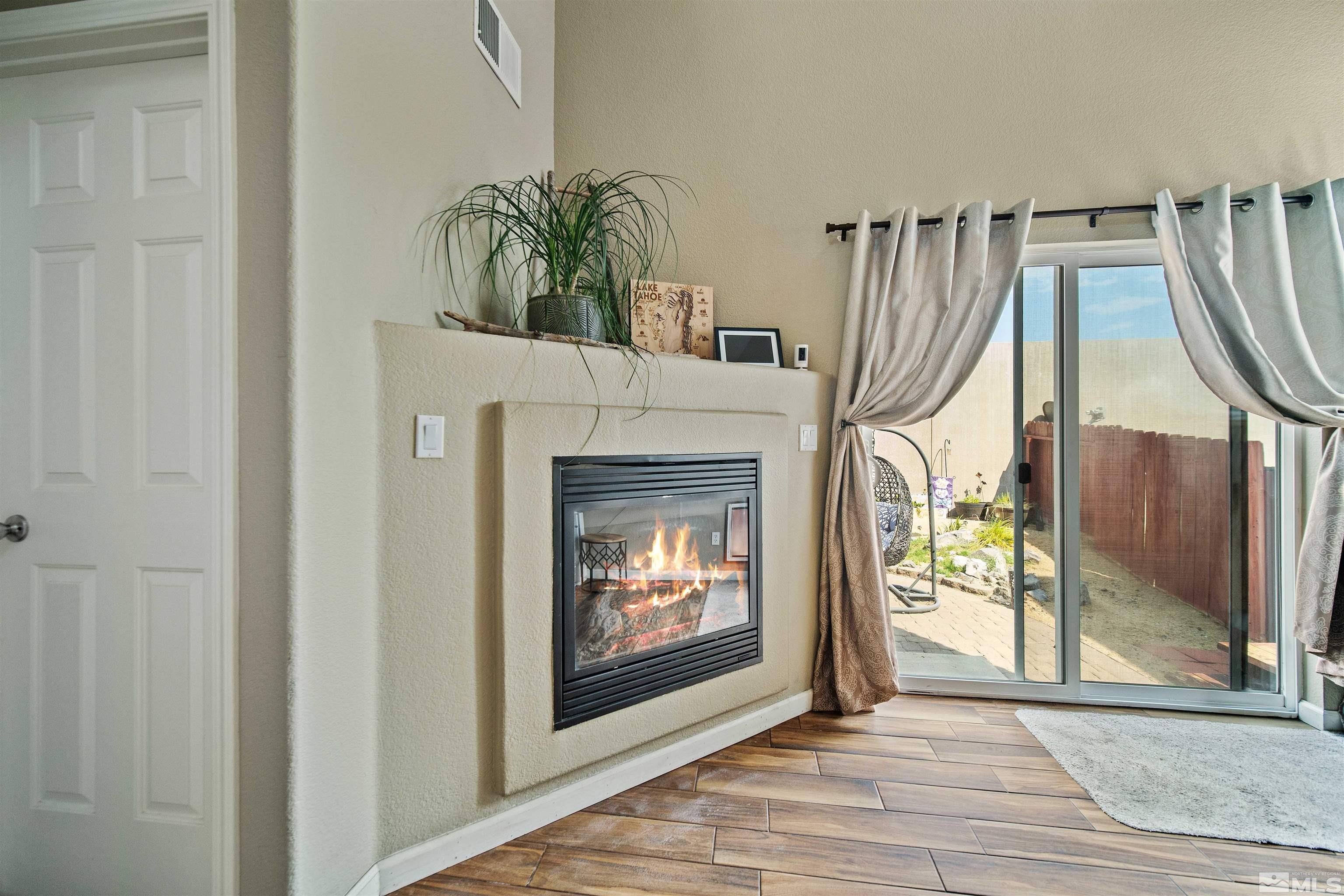 2110 Hellaby Lane Reno, NV 89502 - Photo 6 of 29 a view of an empty room with wooden floor and a fireplace