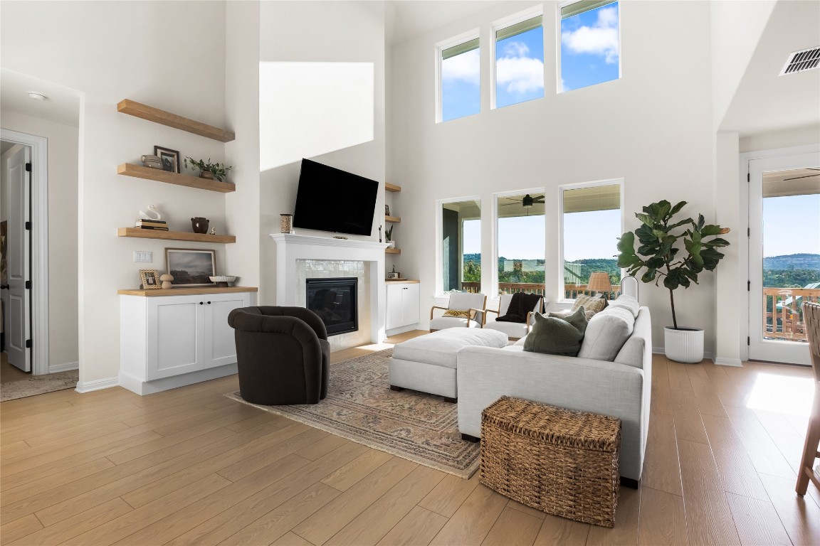 a living room with furniture a flat screen tv and a fireplace