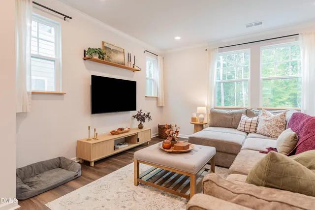 a view of a bedroom with wooden floor and a window