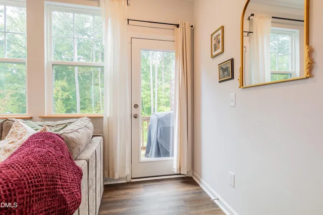 a view of a bedroom with furniture and a window