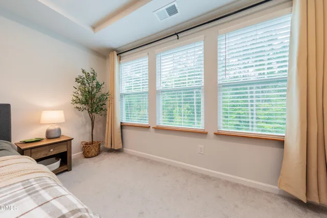 a bed sitting in a bedroom next to a window