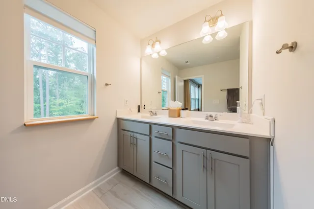 a bathroom with a shower and a glass door