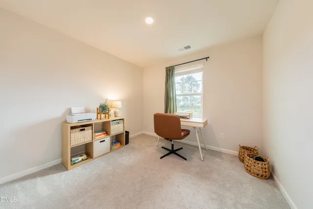 an empty room with closet and windows