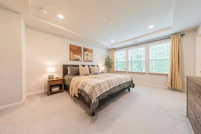 a bedroom with a large bed and a large window