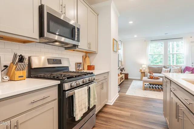a kitchen with stainless steel appliances a stove microwave and cabinets