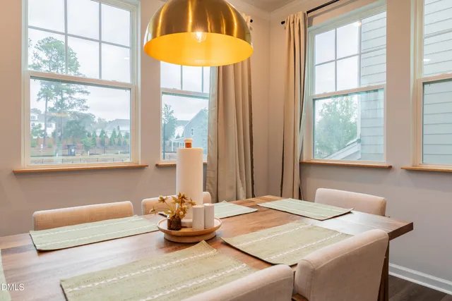 a living room with furniture a flat screen tv and a window