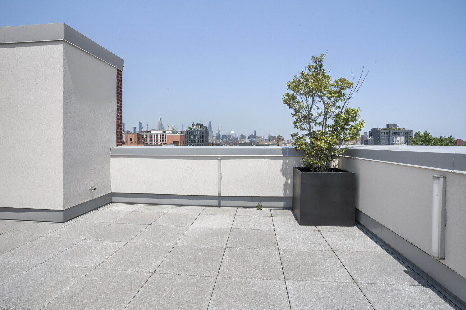 50 Clinton Street, Unit PHB Manhattan, NY 10002 - Photo 12 of 18 a view of a room with a potted plant and a large window