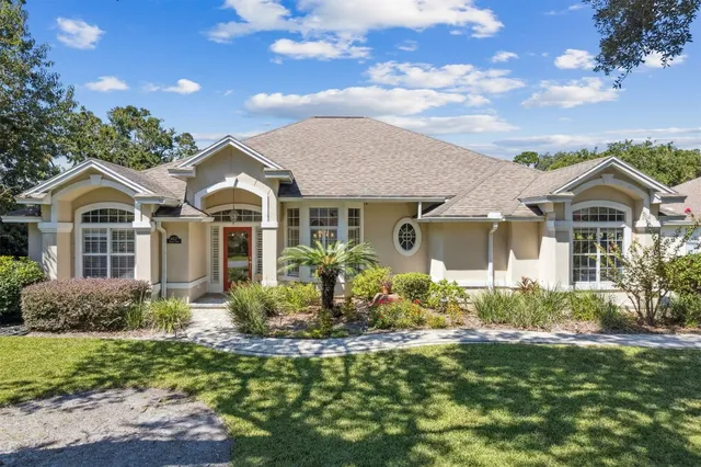a front view of house with yard and green space