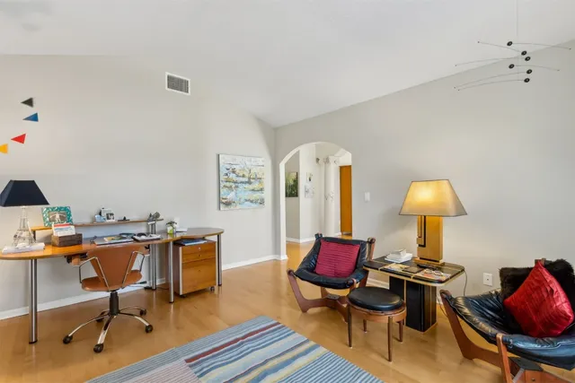 a view of a workspace with furniture and a lamp
