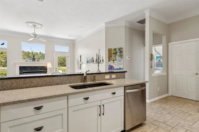 a kitchen with granite countertop a sink and cabinets
