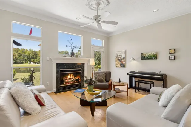 a living room with furniture a fireplace and a window